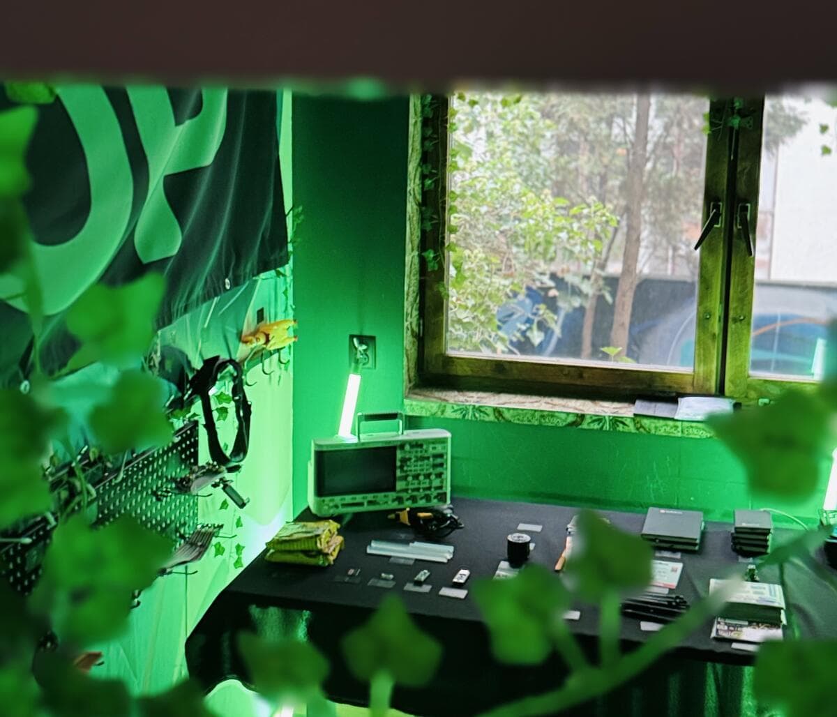An electronics bench with an oscilloscope, lit green